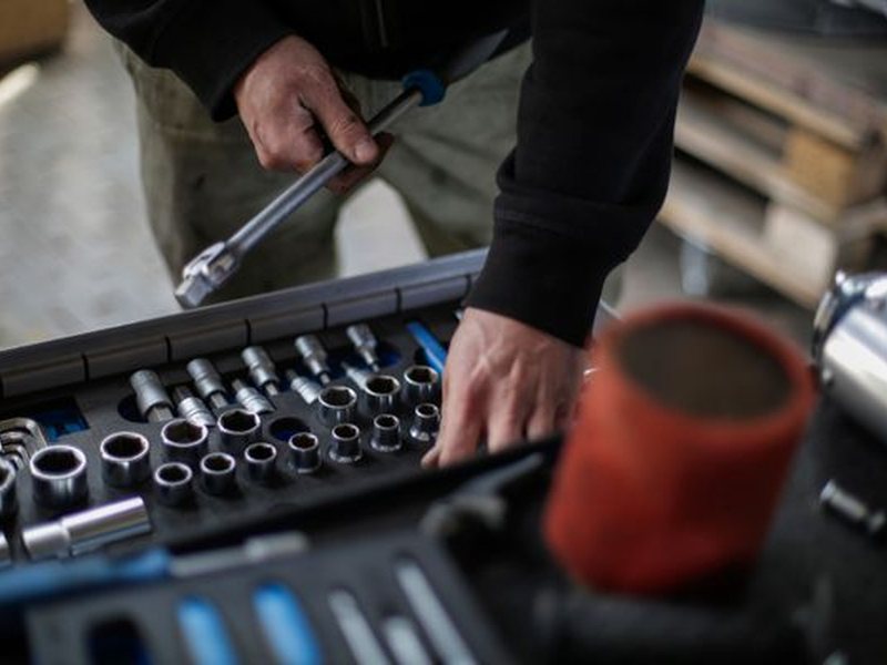 Mechanic selecting sockets from a tool tray