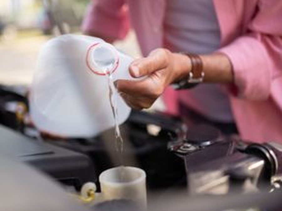 Coolant being poured during a cooling system service