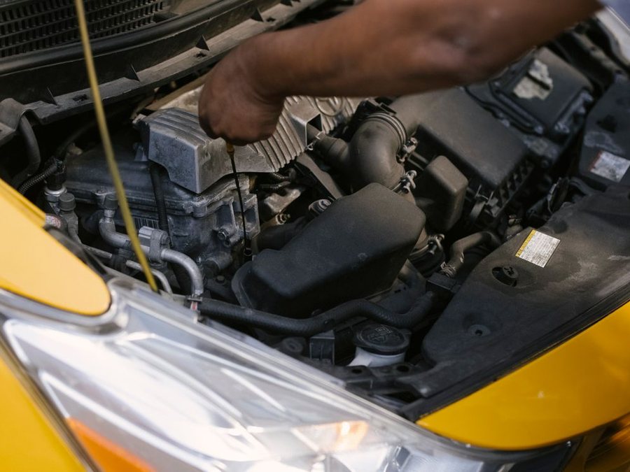 Close-up of a car engine bay during an inspection
