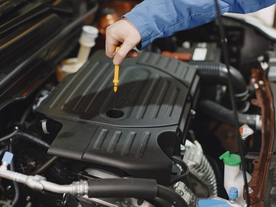 Hand checking the engine oil dipstick